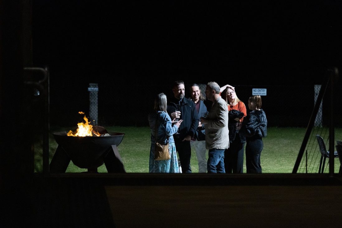 Guests around the firepit on the lawn