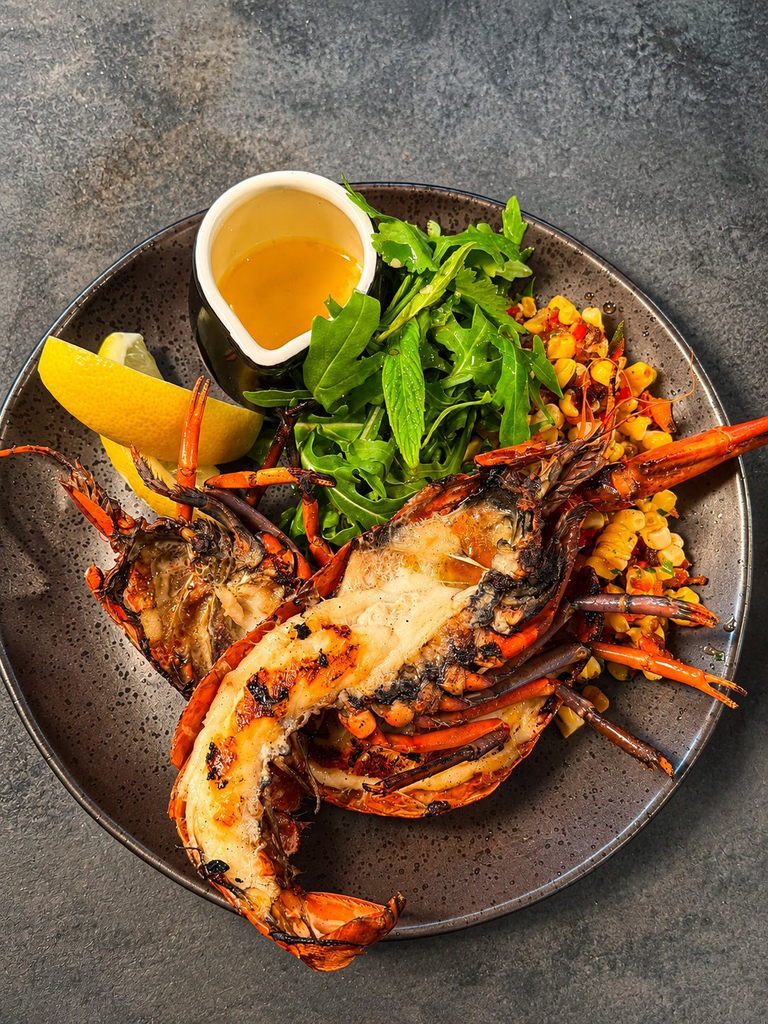 Grilled marron with garlic butter, rocket and corn salsa